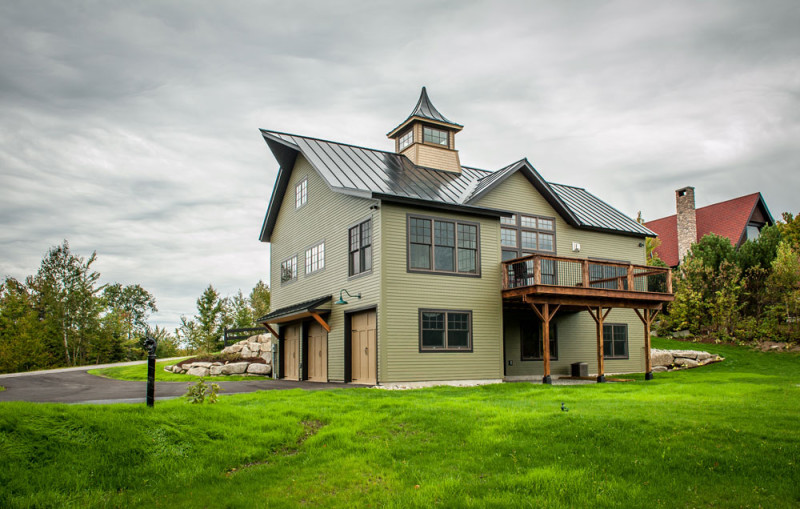 Back exterior of barn house with deck