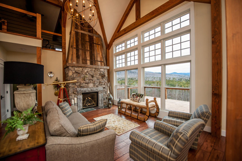 Stone fireplace in living room with beamed ceilings