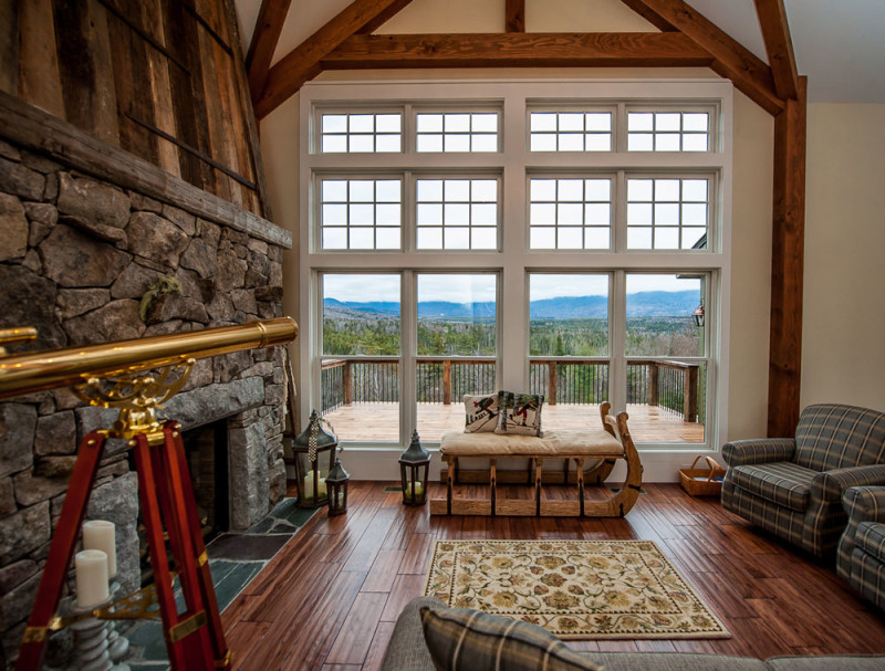 Large window overlooking deck and view of mountains