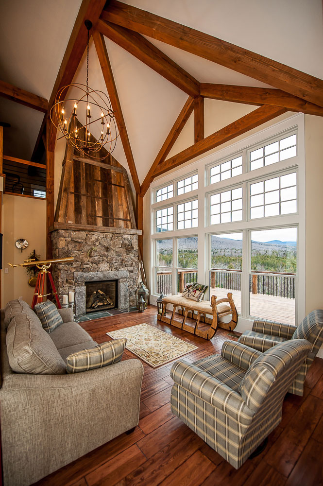 A living room with tall stone fireplace