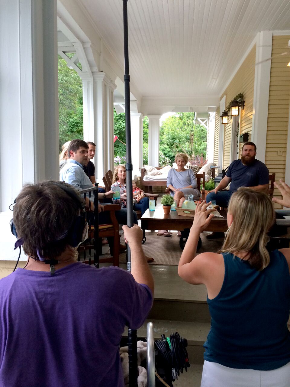 Erin and Ben Napier filming scene on front porch for HGTV\'s Home Town