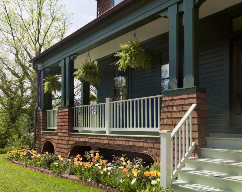 A close up of a flower garden in front of a house