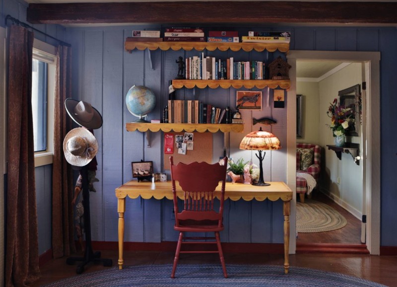 Desk with red chair and floating shelves