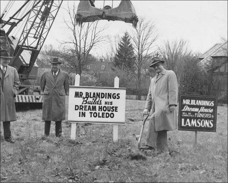 Old photo of men with sign saying Mr. Blandings Builds His Dream House in Toledo