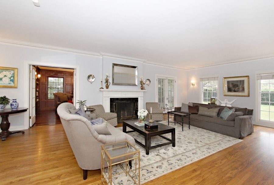 A living room filled with furniture on top of a hard wood floor