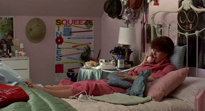 Screenshot of Molly Ringwald talking on the phone in bed