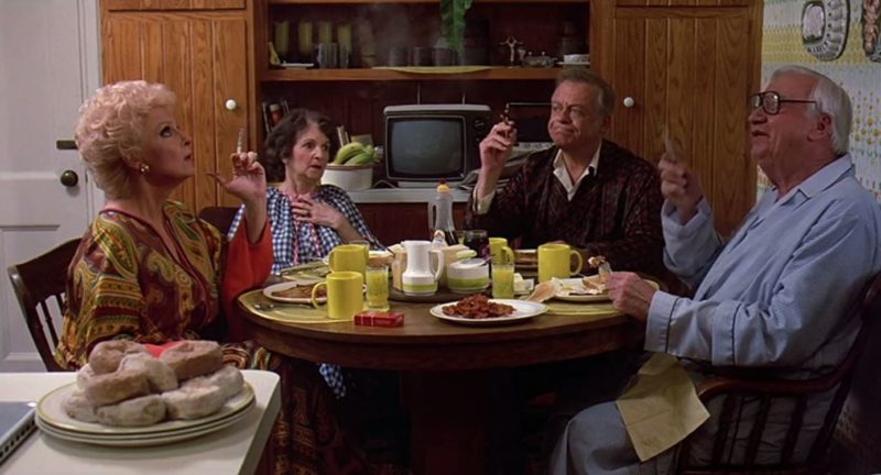 A group of people sitting at kitchen table at breakfast