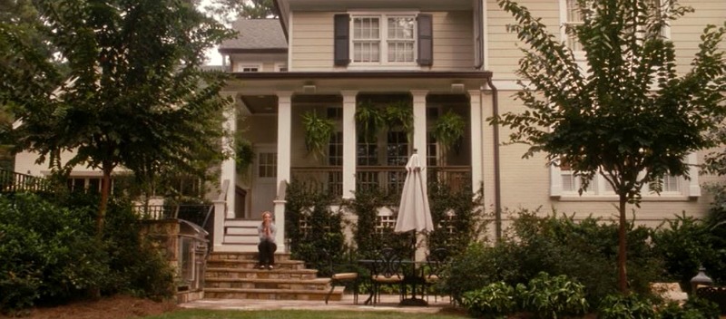 Back of the house with porch and steps leading to patio