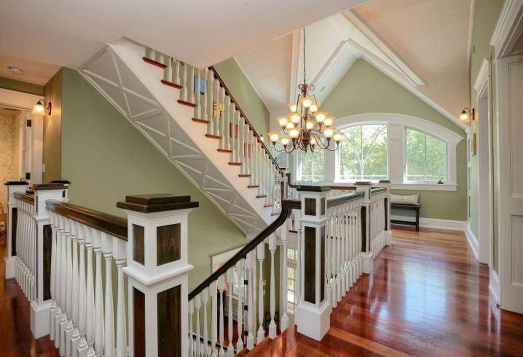 Upstairs landing with large half-moon window and chandelier