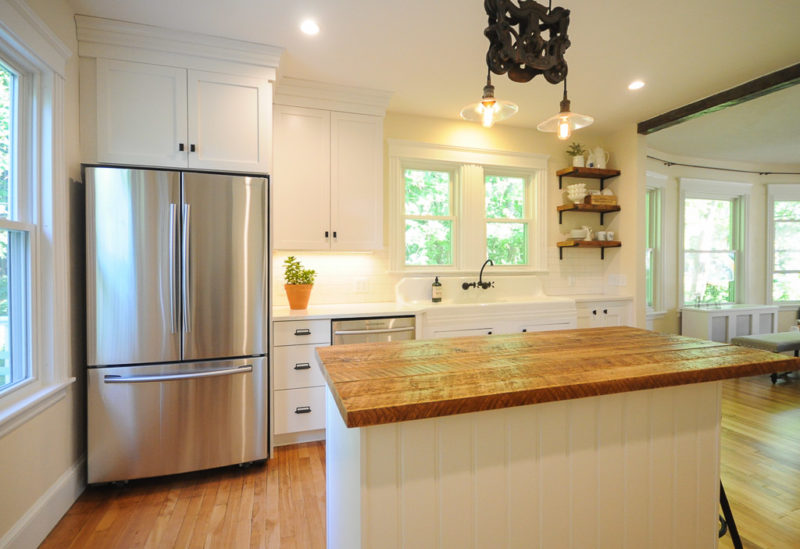 Newly remodeled kitchen with white cabinets and stainless steel appliances