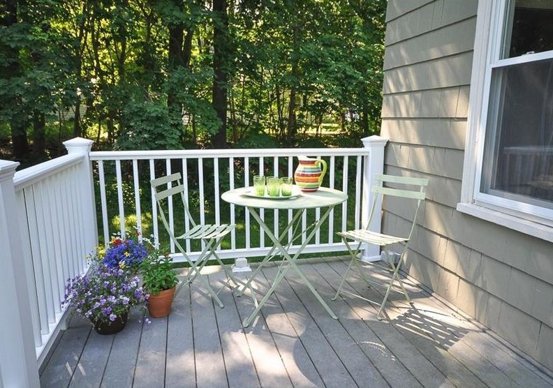 Deck with table and two chairs overlooking the yard