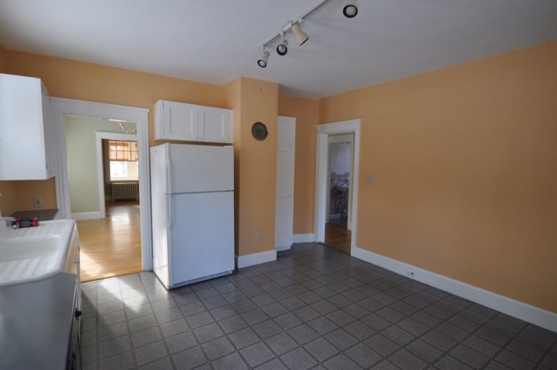 Kitchen with tile floor and track lighting before remodel