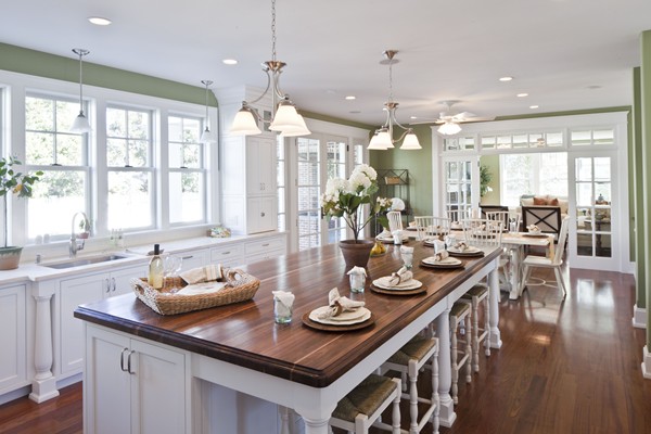 White kitchen with green walls and oversize island