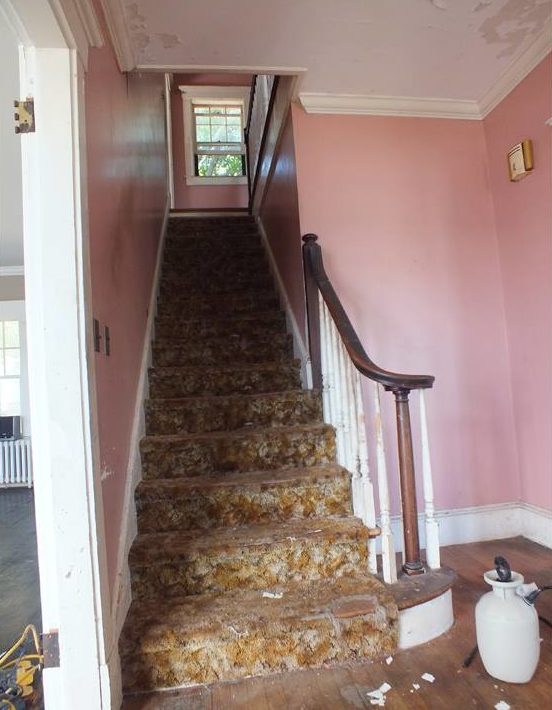 Staircase with pink walls and old carpet