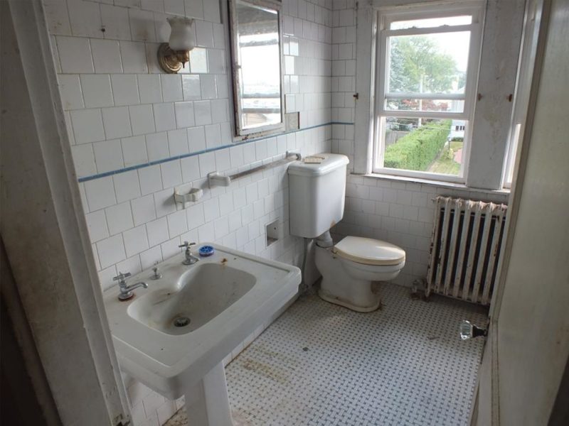 Bathroom with radiator before remodel