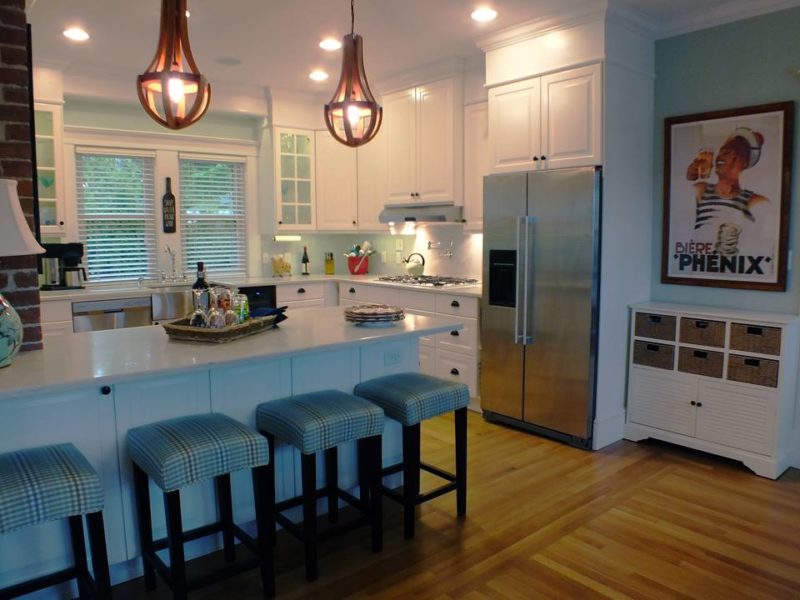 New kitchen with stainless steel refrigerator and bar stools