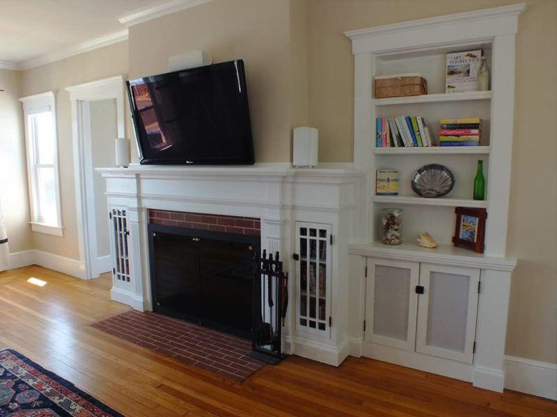 Living room fireplace with bookshelves after remodel