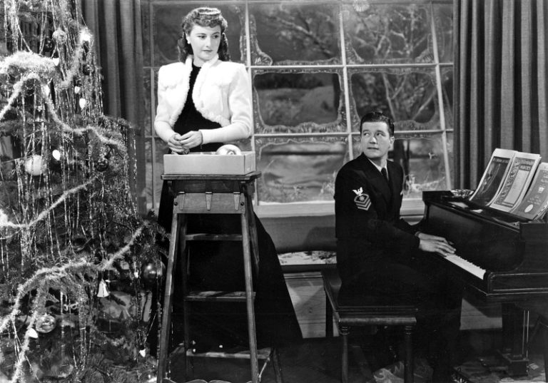 Barbara Stanwyck and Dennis Morgan by the tree in Christmas in Connecticut