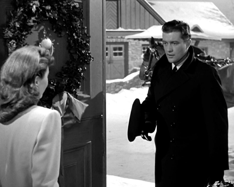 Dennis Morgan enters the front door of the farmhouse