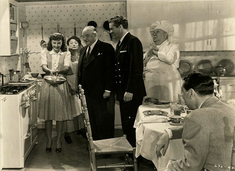 Elizabeth Lane flipping pancakes in promotional still for Christmas in Connecticut