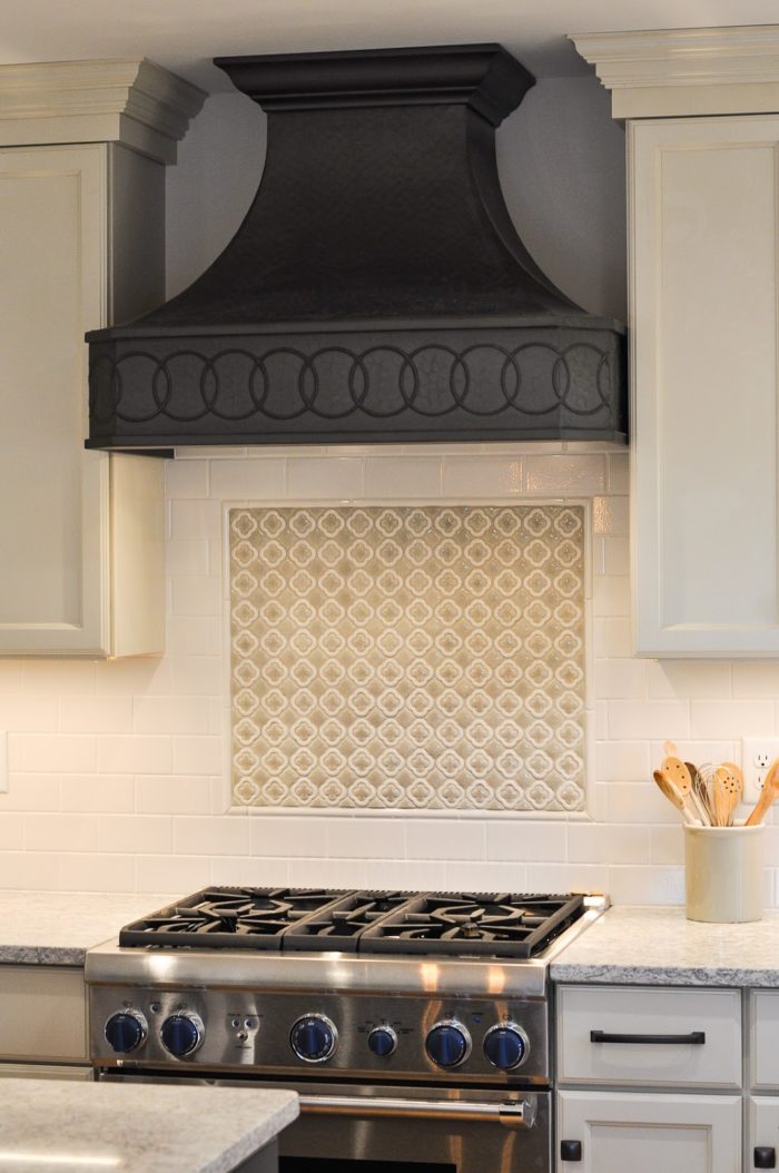 Closeup of oven stovetop and vent hood