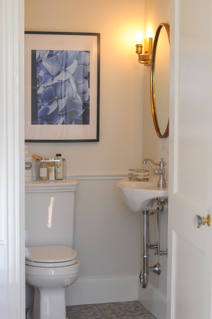 Closet after it was turned into small powder room with toilet and sink