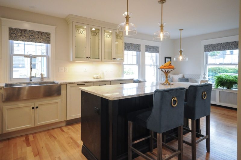 Kitchen after remodel with new marble-topped island and white cabinets