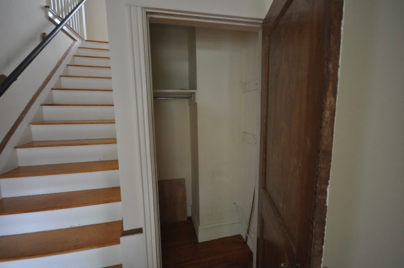 Open door showing inside closet before remodel