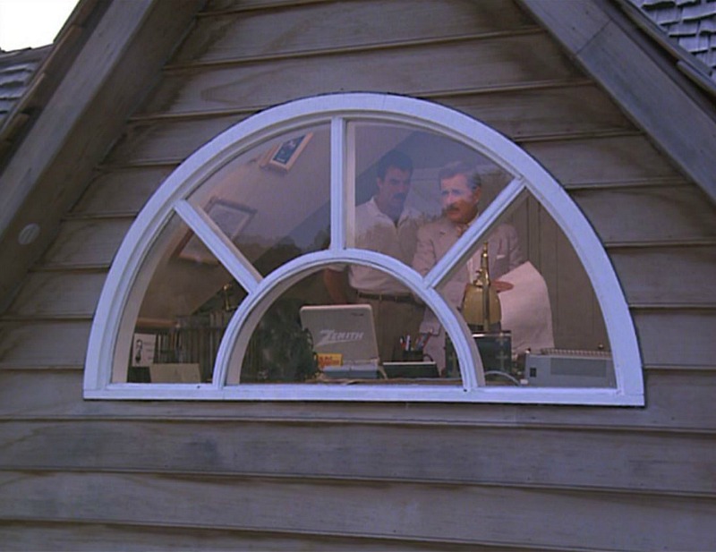 Looking through half-moon window into attic study