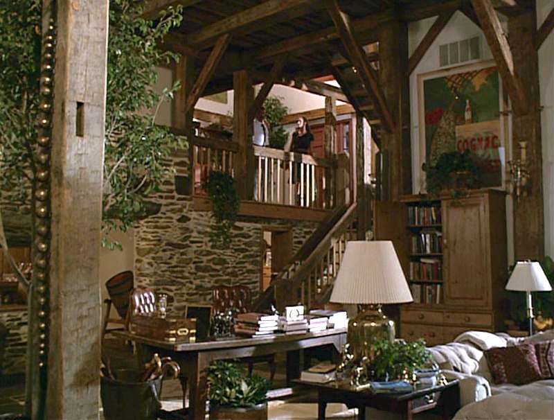 A living room filled with furniture and vase of flowers on a table