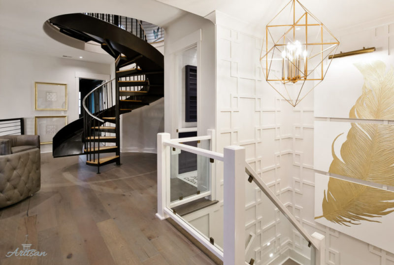 Stairwell leading to lower level beside spiral staircase leading to upper level