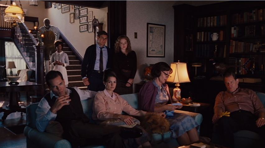 A group of people sitting around a living room