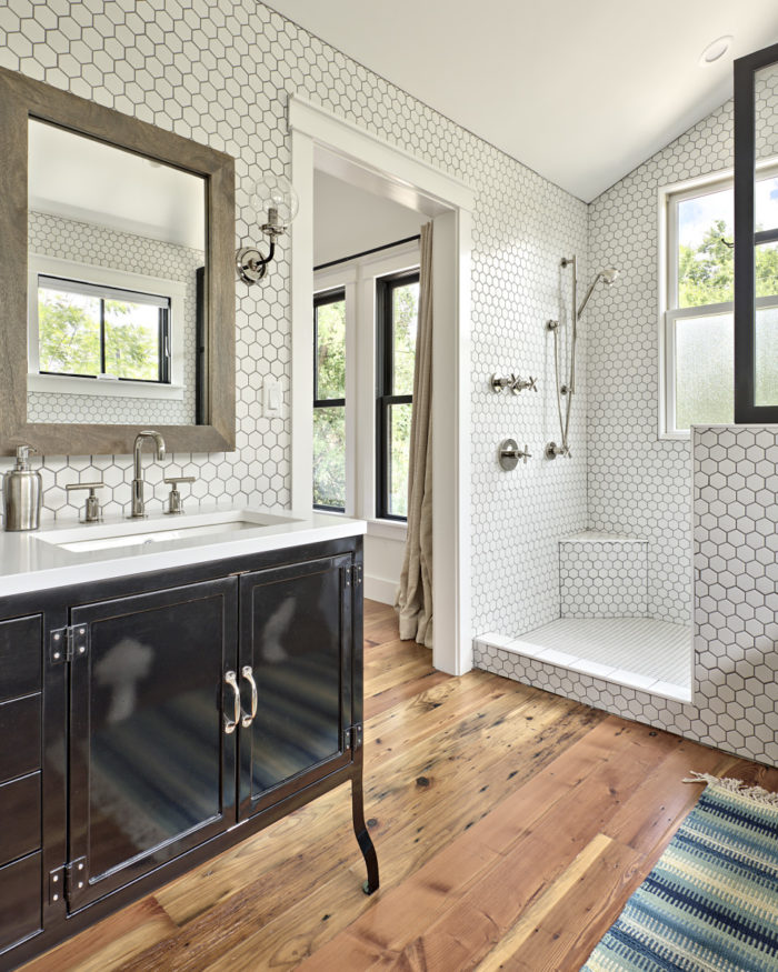 Bathroom with black vanity and white tile