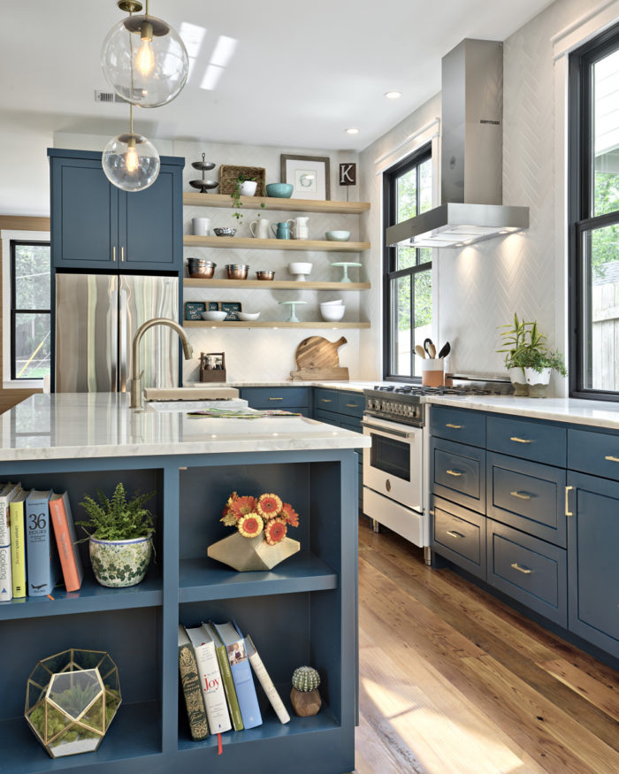 Blue kitchen with white range and stainless hood vent