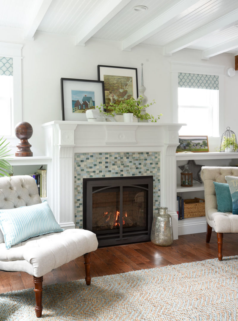 A living room fireplace with blue and green tiles