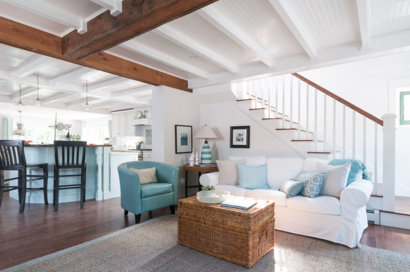 A living room filled with furniture and staircase