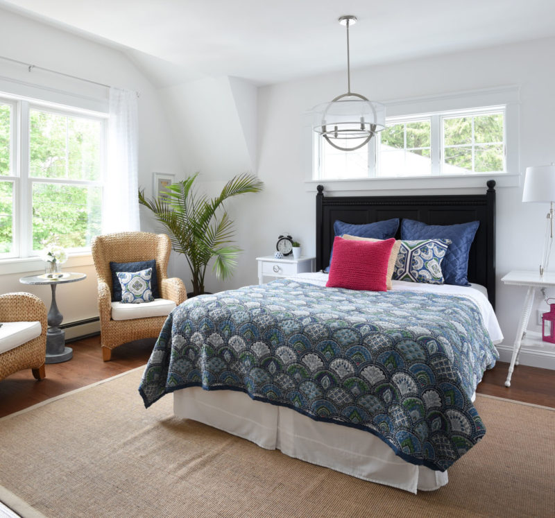 A bedroom with a bed and window in a room