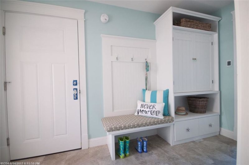 Mudroom with beadboard on wall and built-in bench