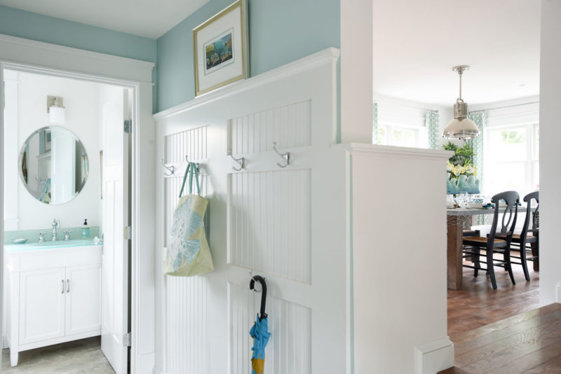 Beadboard in mudroom with hooks for coats