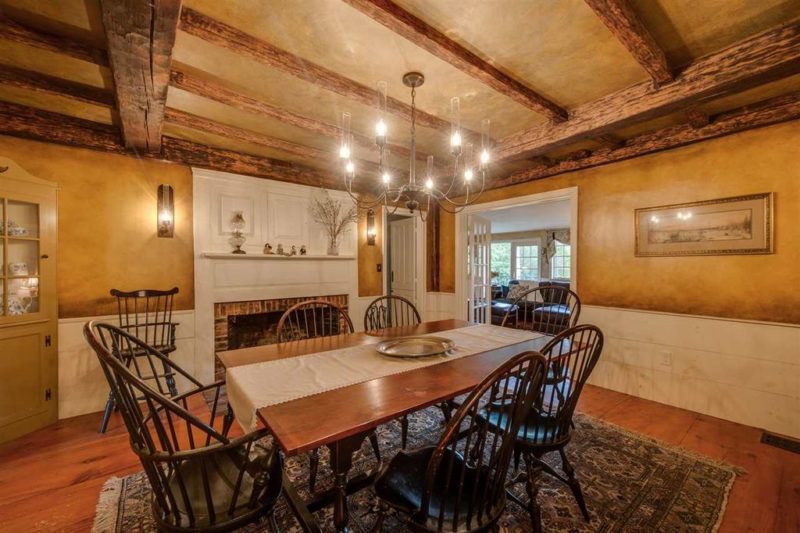 Dining room with fireplace and beamed ceiling