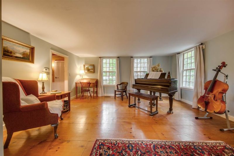 A living room filled with furniture on top of a hard wood floor