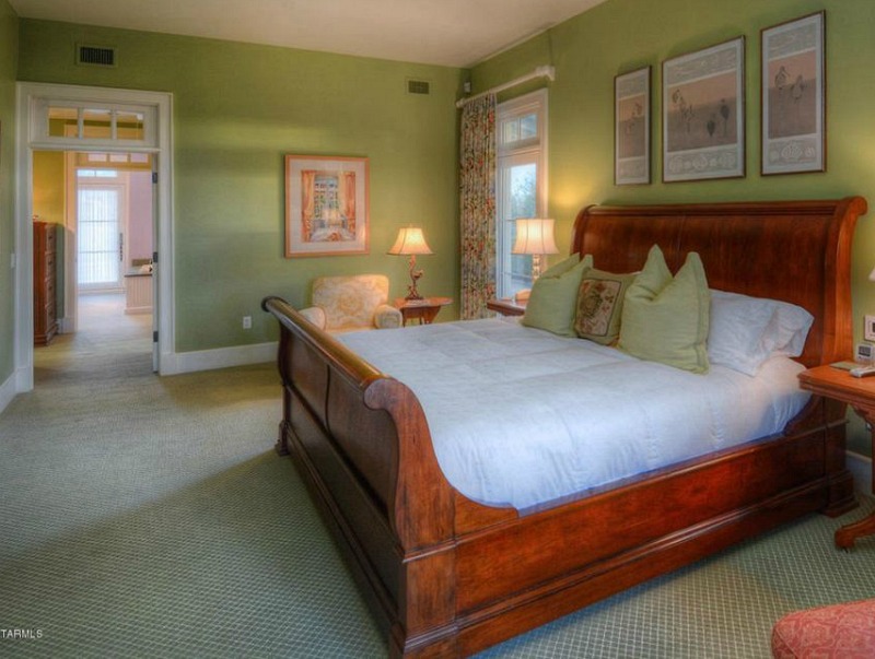 Bedroom with sleigh bed and green walls