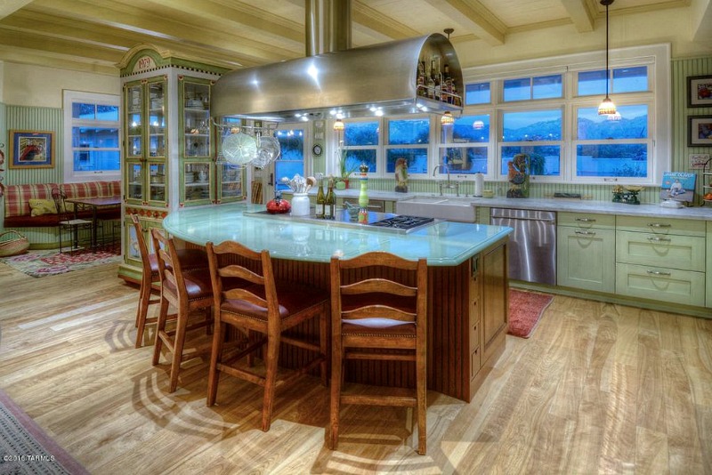 Kitchen with large curved island and bar stools