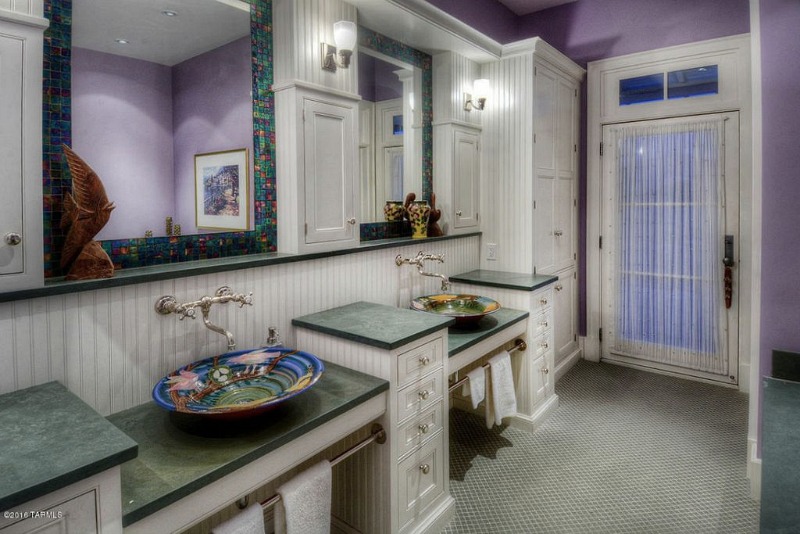 Purple bathroom with two bowl sinks and green countertops