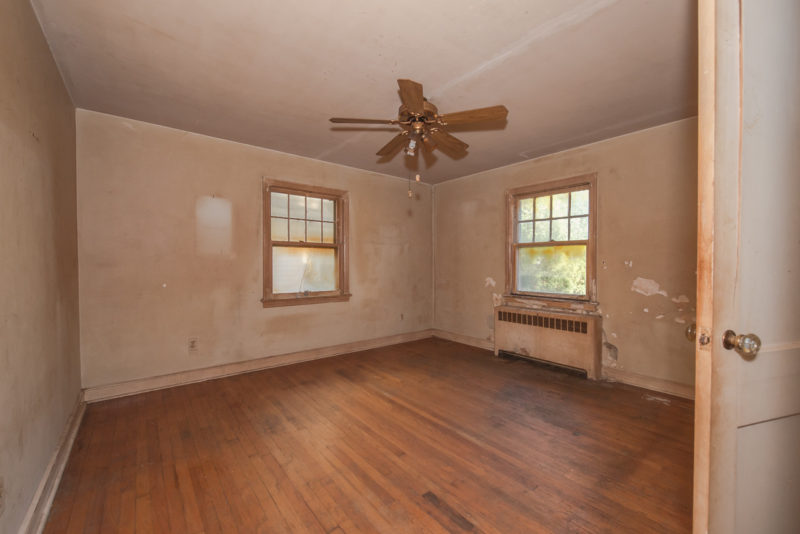 A large empty room with a hard wood floor