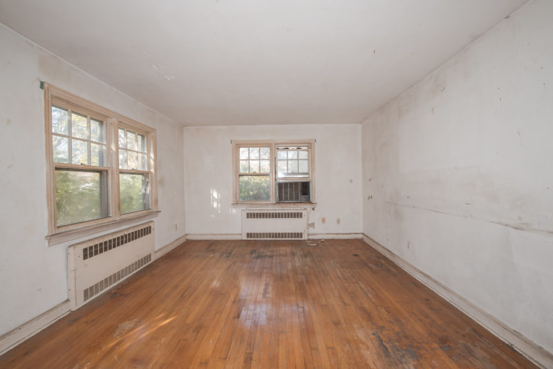 A large empty room with a hard wood floor