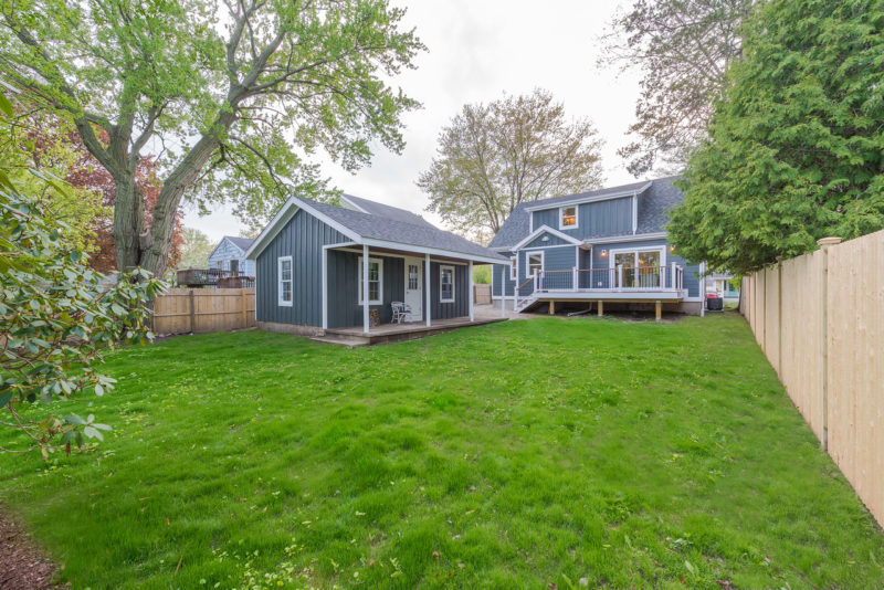 Back of Cape after remodel with new blue siding