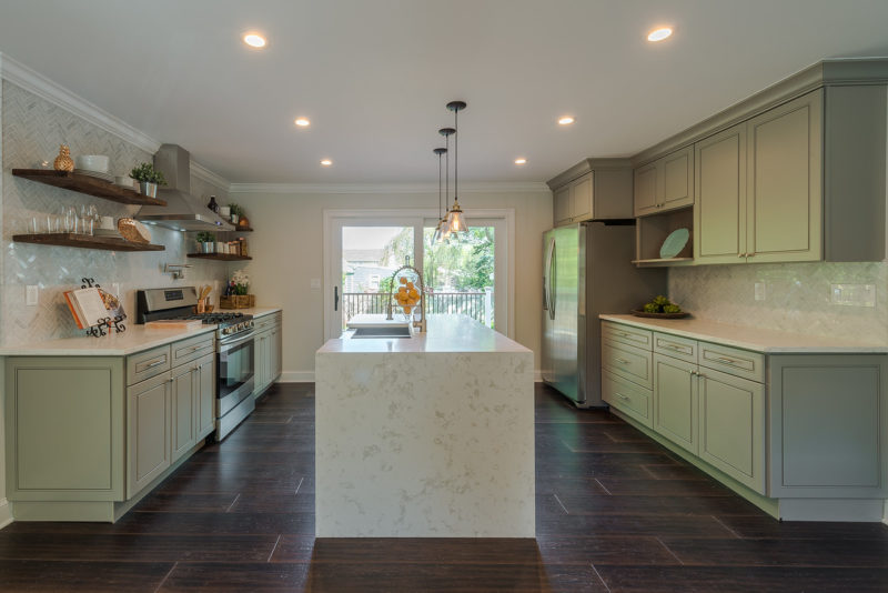 A kitchen with a wood floor and center island