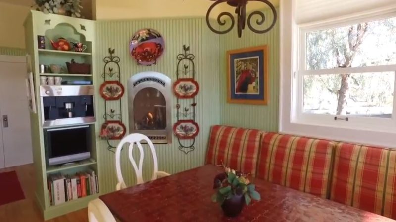 kitchen nook with banquette and fireplace