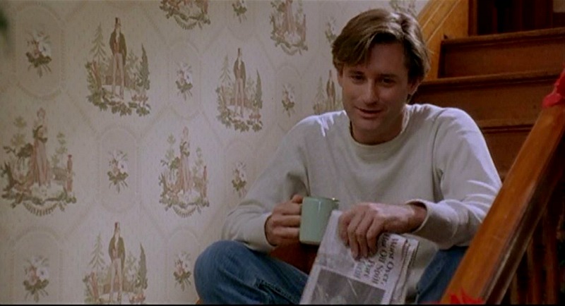 Bill Pullman sitting on the stairs with coffee